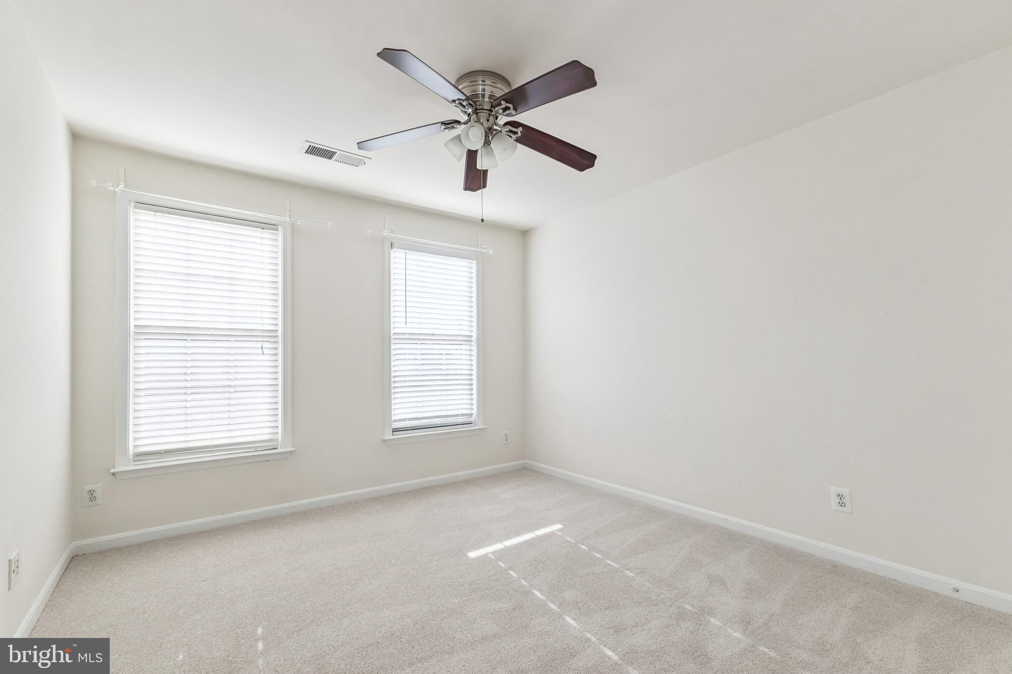 13083 Rose Petal Circle Herndon, VA 20171 - Photo 17 of 29 an empty room with ceiling fan and windows