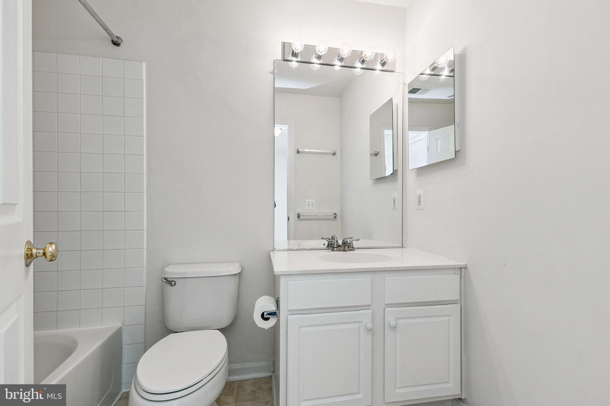 13083 Rose Petal Circle Herndon, VA 20171 - Photo 19 of 29 a bathroom with a sink a toilet a mirror and shower