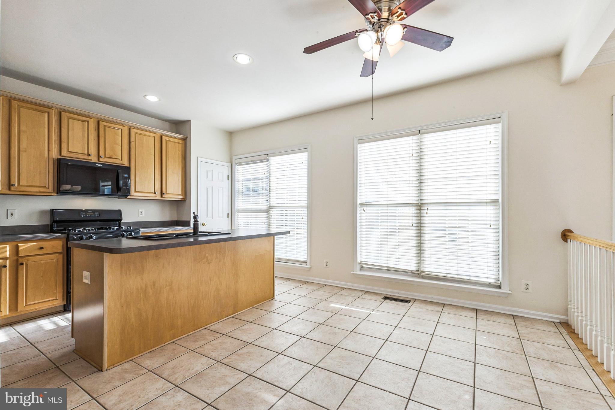13083 Rose Petal Circle Herndon, VA 20171 - Photo 2 of 29 a large kitchen with stainless steel appliances granite countertop a stove a sink and a microwave