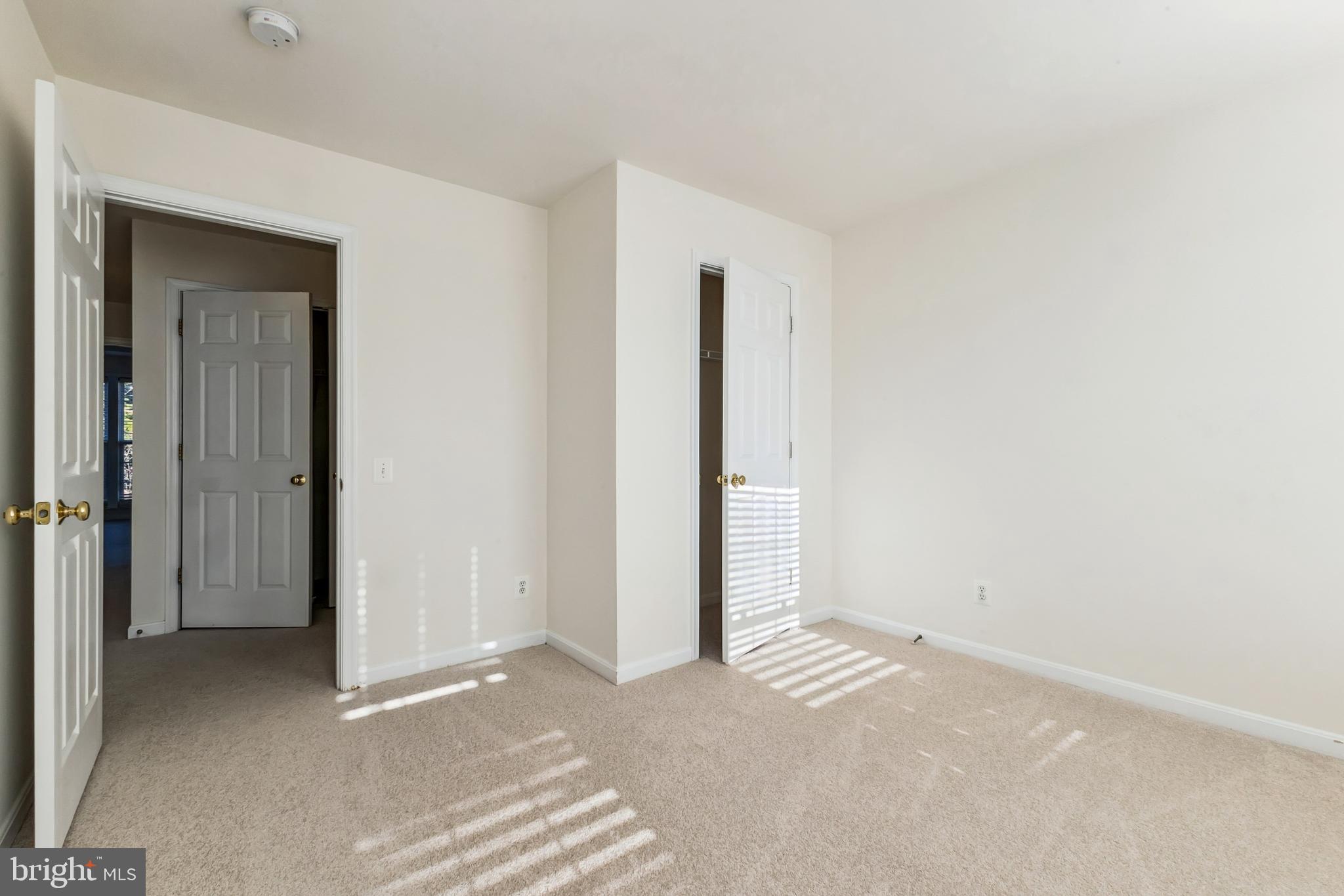 13083 Rose Petal Circle Herndon, VA 20171 - Photo 21 of 29 a view of a room with a hallway and closet