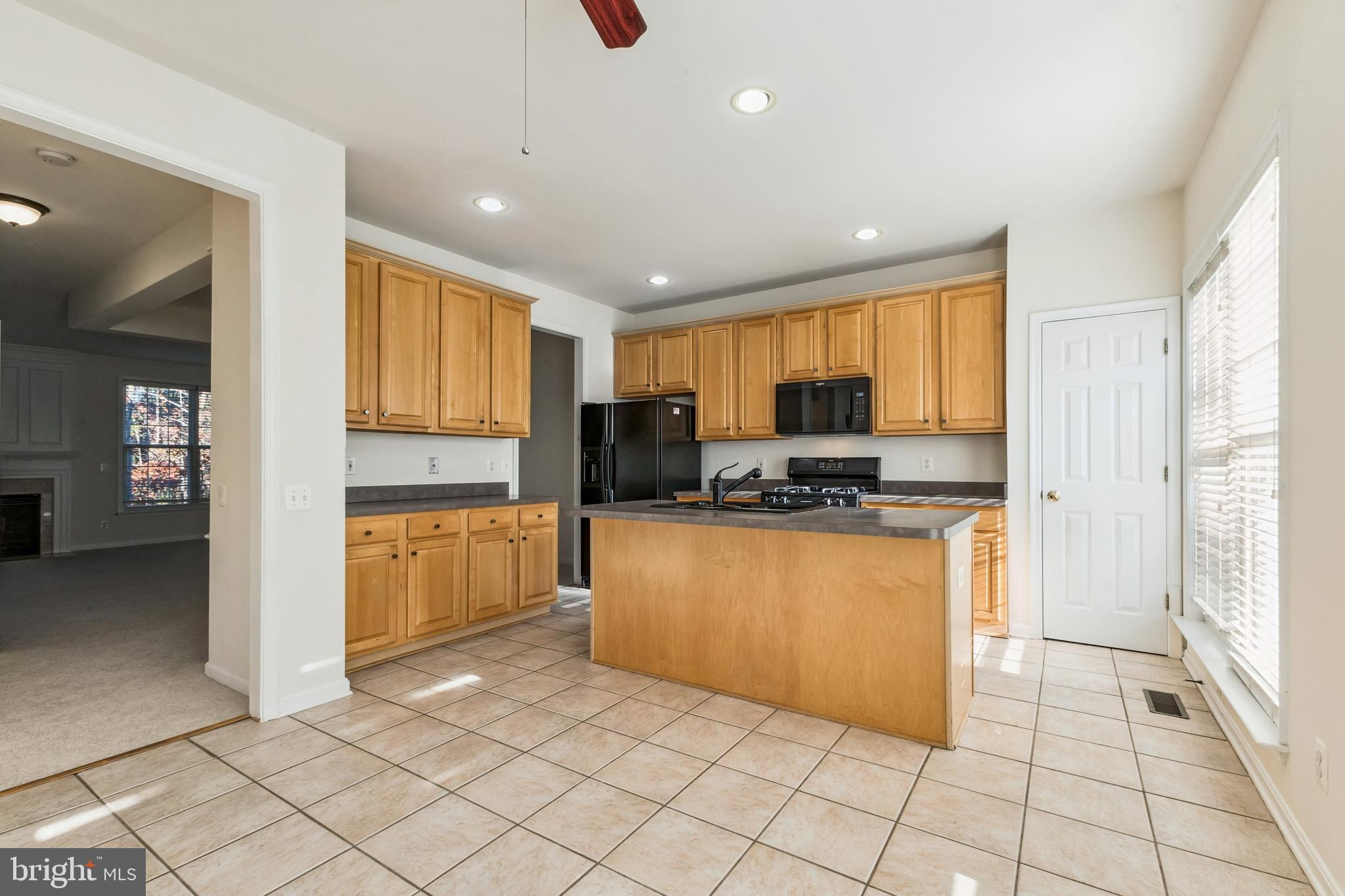 13083 Rose Petal Circle Herndon, VA 20171 - Photo 3 of 29 a kitchen with stainless steel appliances granite countertop a refrigerator and a stove top oven