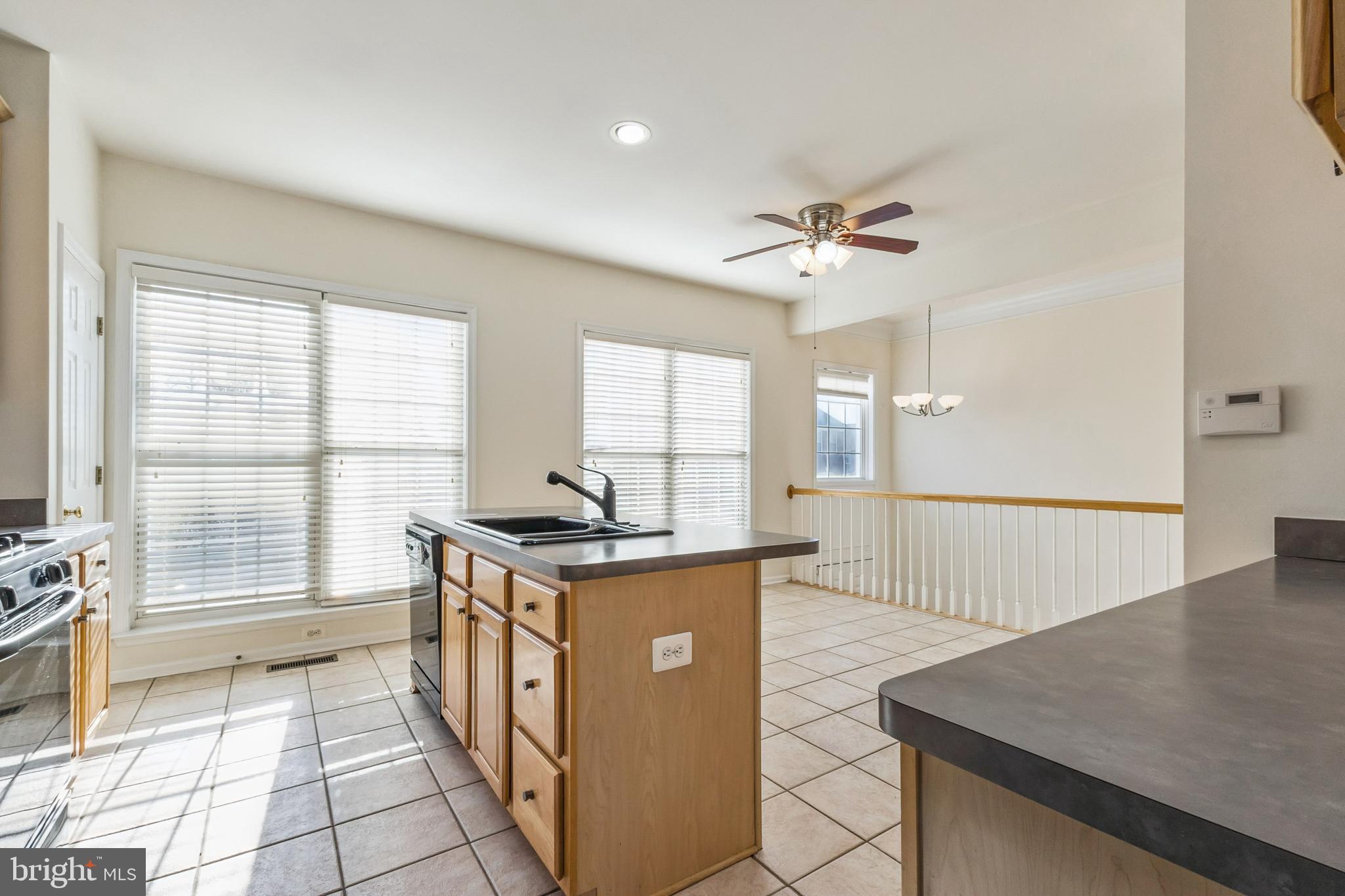 13083 Rose Petal Circle Herndon, VA 20171 - Photo 5 of 29 a kitchen with stainless steel appliances granite countertop a stove a sink and a refrigerator