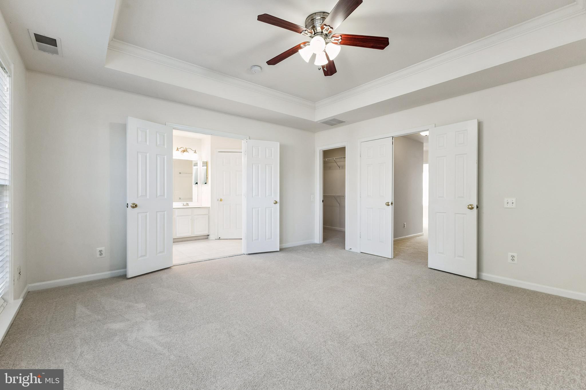 13083 Rose Petal Circle Herndon, VA 20171 - Photo 10 of 29 an empty room with closet and a ceiling fan