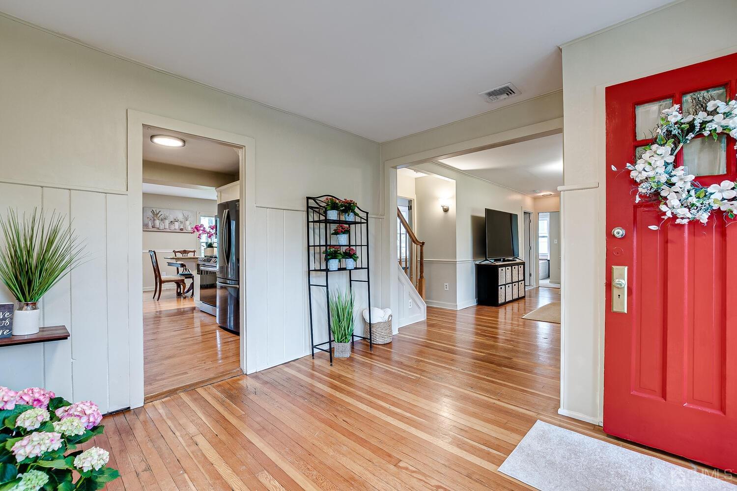 13 Herron Road Edison, NJ 08820 - Photo 16 of 51 a view of a hallway with wooden floor and a potted plant