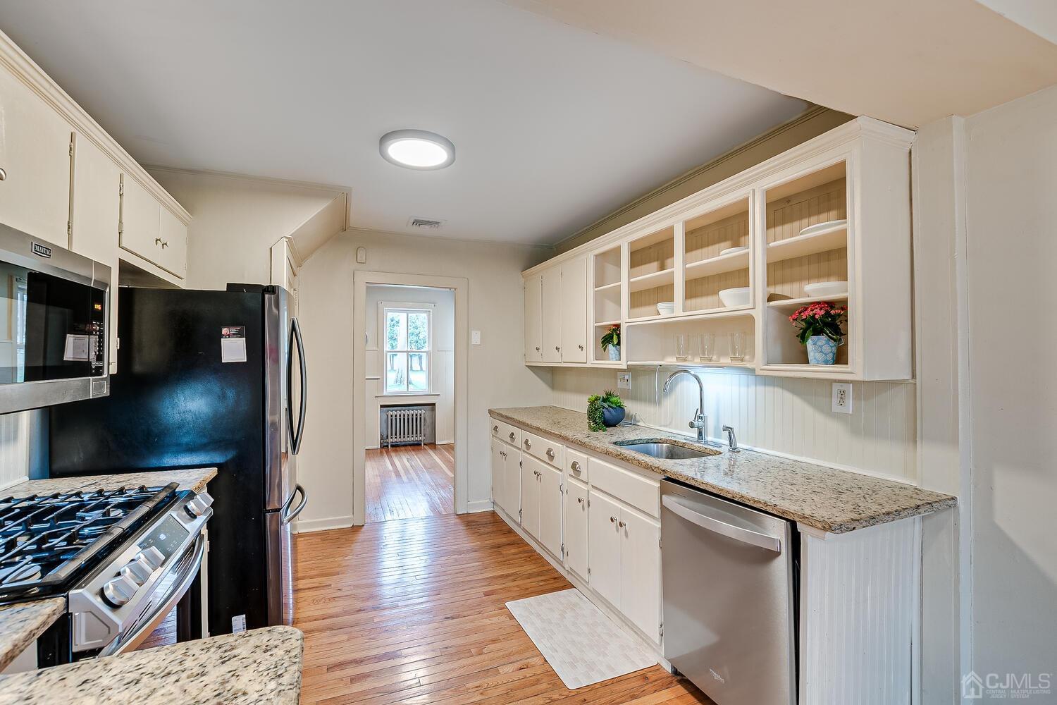 13 Herron Road Edison, NJ 08820 - Photo 25 of 51 a kitchen with granite countertop a sink and a stove top oven