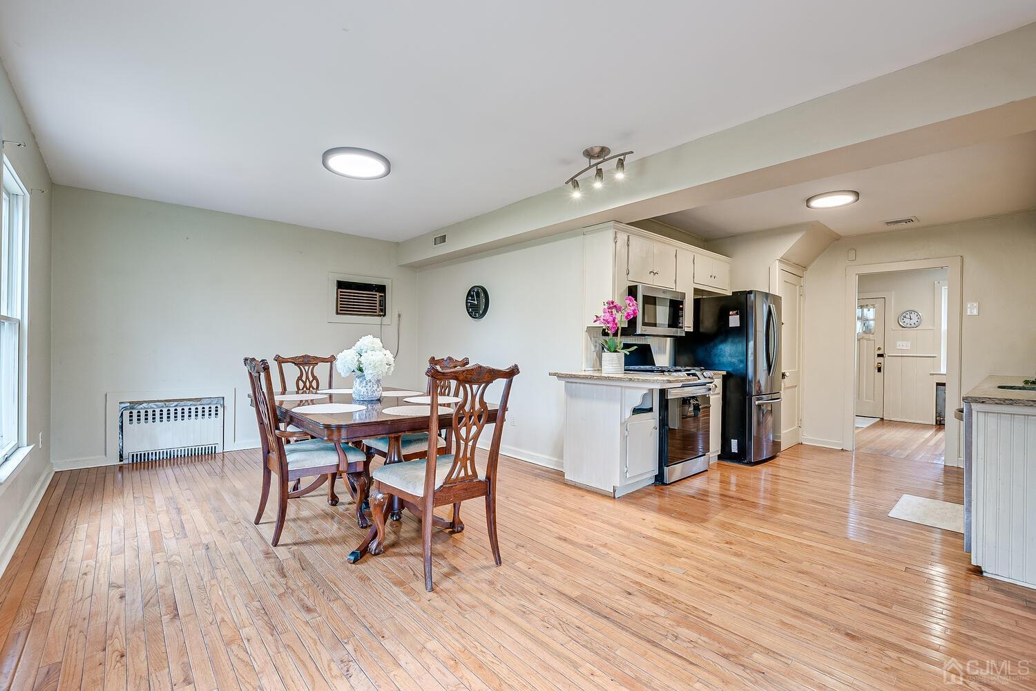 13 Herron Road Edison, NJ 08820 - Photo 27 of 51 a view of a dining room with furniture and wooden floor