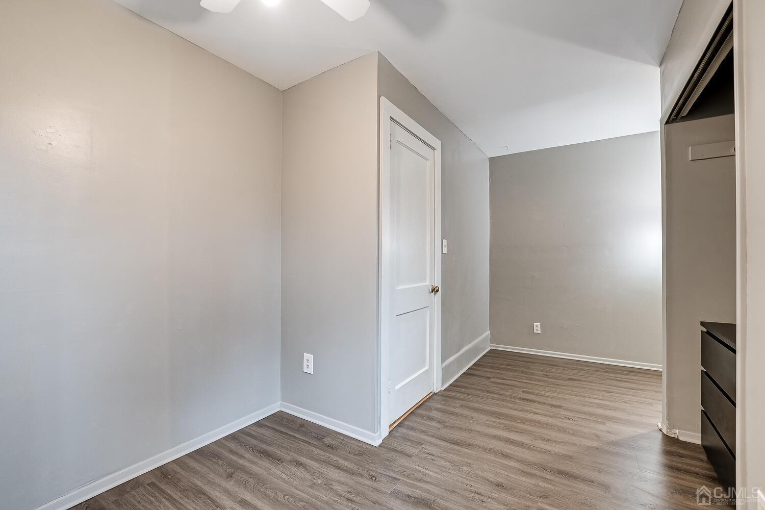 13 Herron Road Edison, NJ 08820 - Photo 35 of 51 a view of an empty room with wooden floor and a window