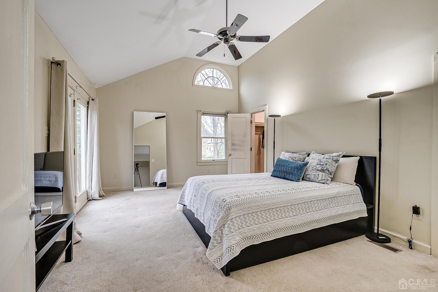 13 Herron Road Edison, NJ 08820 - Photo 38 of 51 a bedroom with a bed and a chandelier