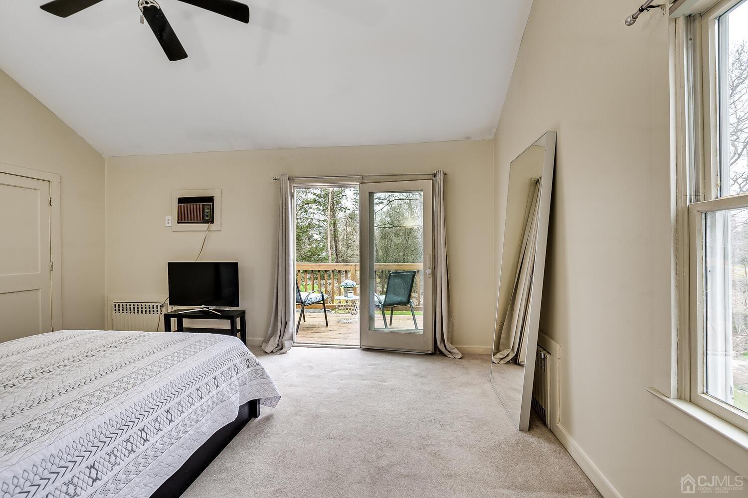 13 Herron Road Edison, NJ 08820 - Photo 40 of 51 a bedroom with a bed flat screen tv and large window