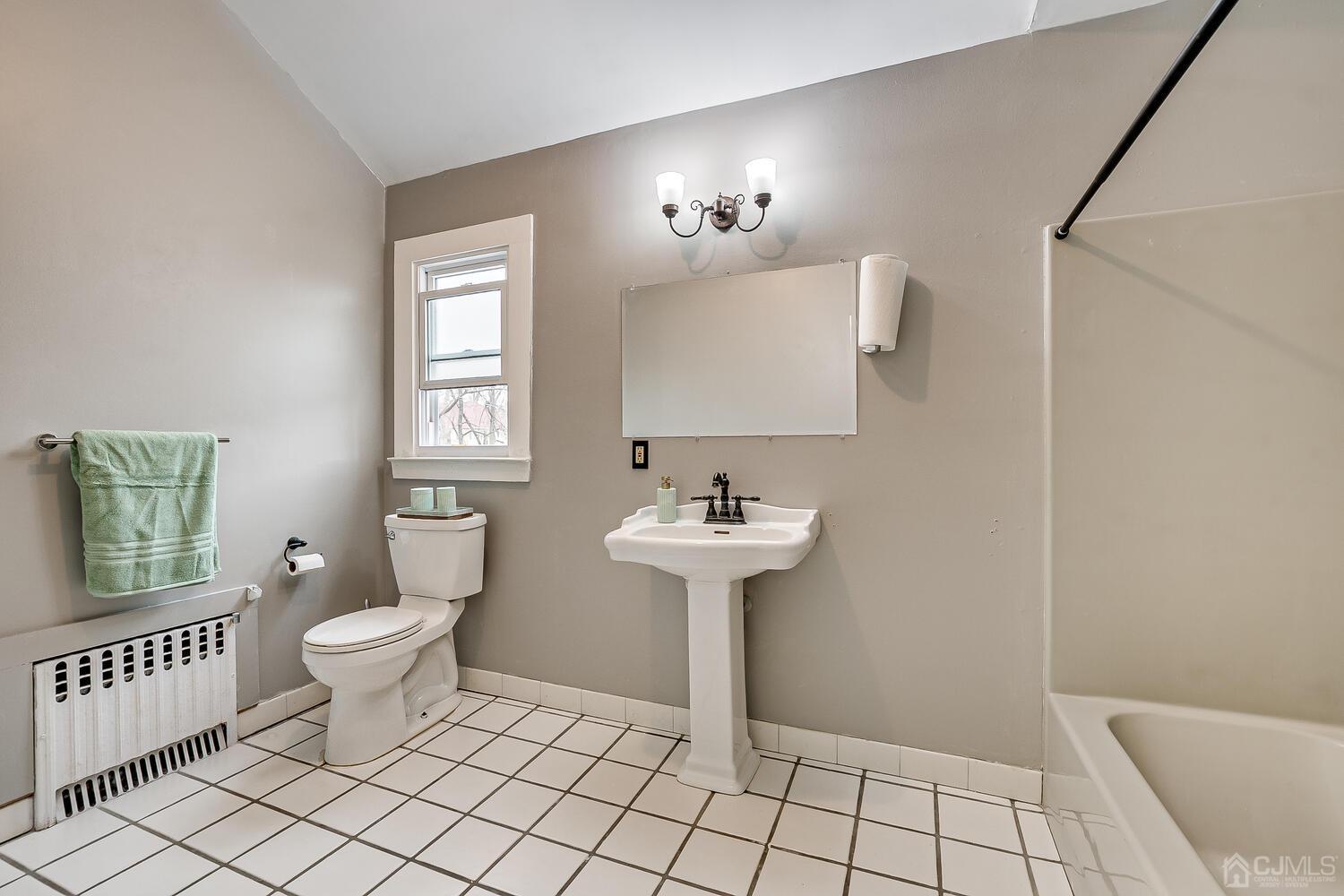 13 Herron Road Edison, NJ 08820 - Photo 42 of 51 a bathroom with a sink toilet and a mirror