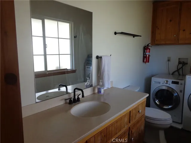a kitchen with a sink a stove and cabinets