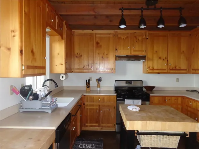 a living room with furniture and large windows