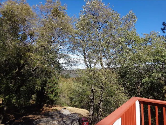 a living room with a couch and a dining table with wooden floor