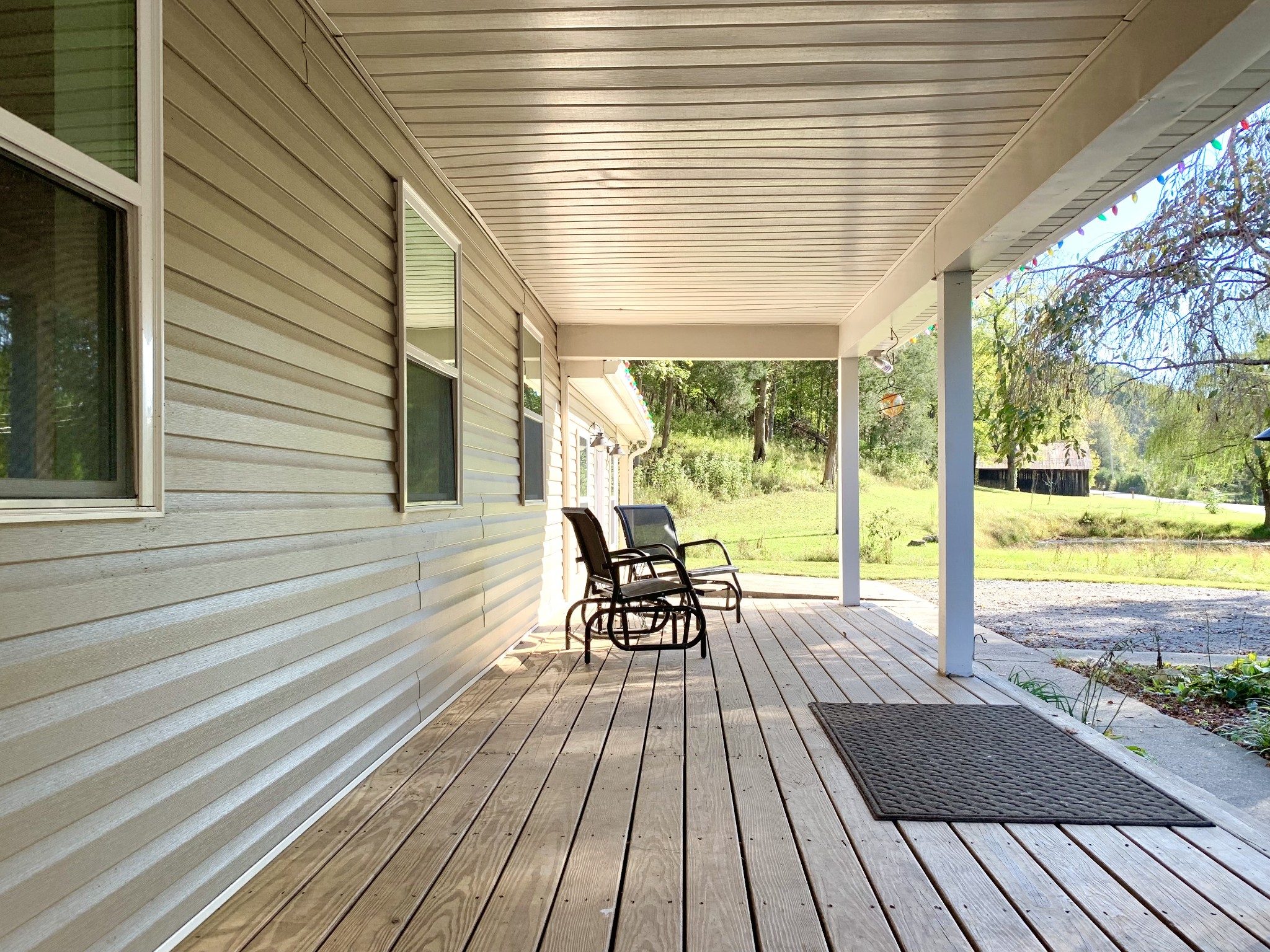 3979 Lem Davis Road Cunningham, TN 37052 - Photo 11 of 70 a view of a patio with table and chairs next to window with wooden floor