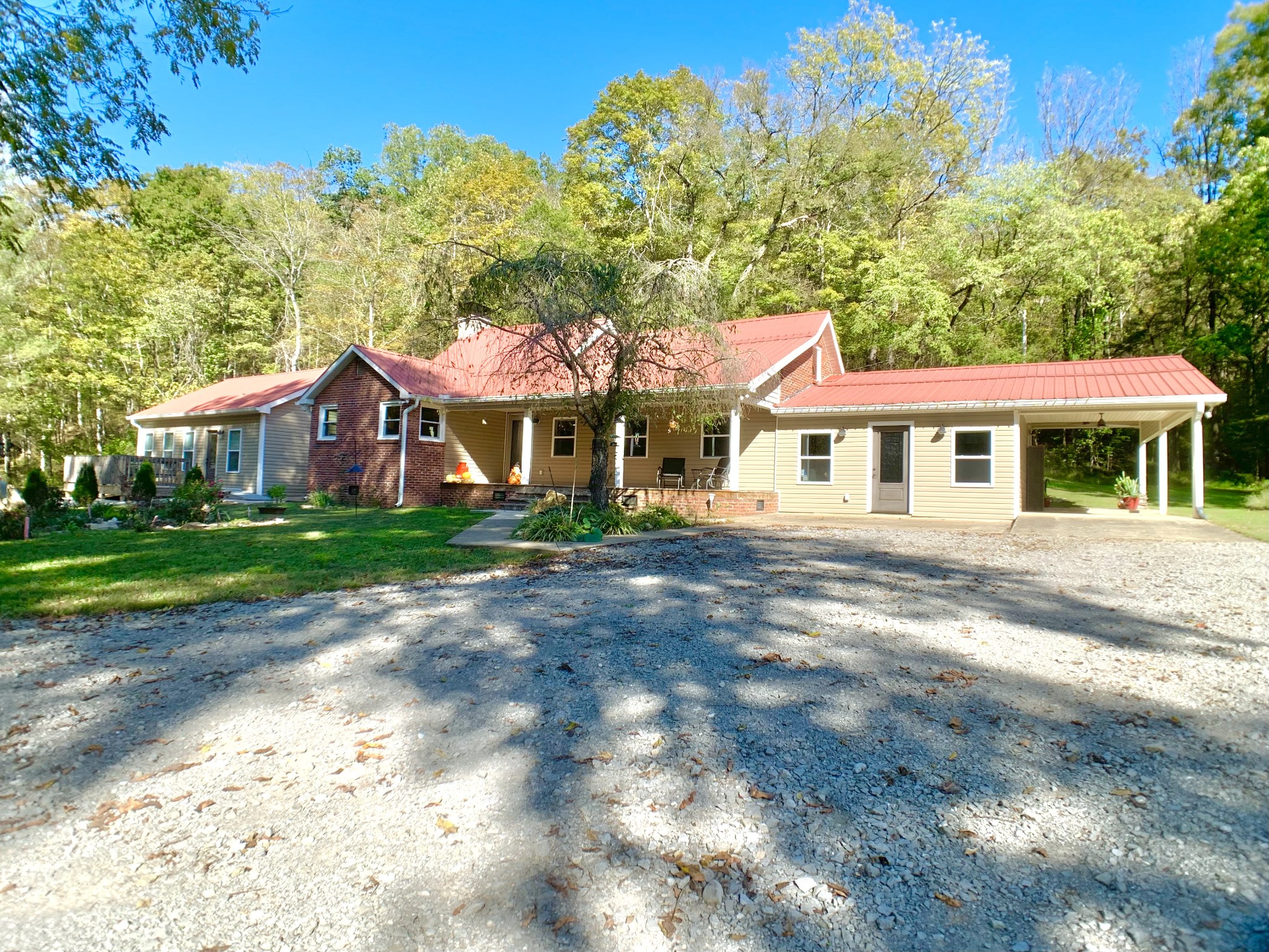 3979 Lem Davis Road Cunningham, TN 37052 - Photo 2 of 70 a view of a white house with a yard plants and large tree