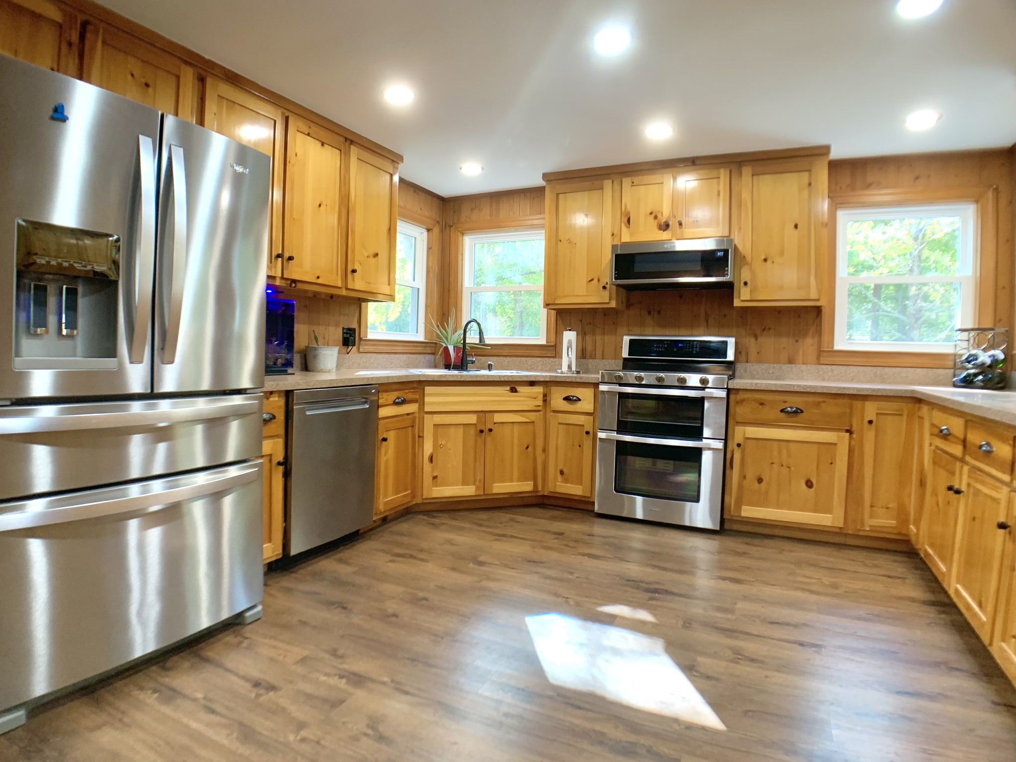 3979 Lem Davis Road Cunningham, TN 37052 - Photo 23 of 70 a kitchen with stainless steel appliances granite countertop a sink a stove a refrigerator with grey cabinets and wooden floor