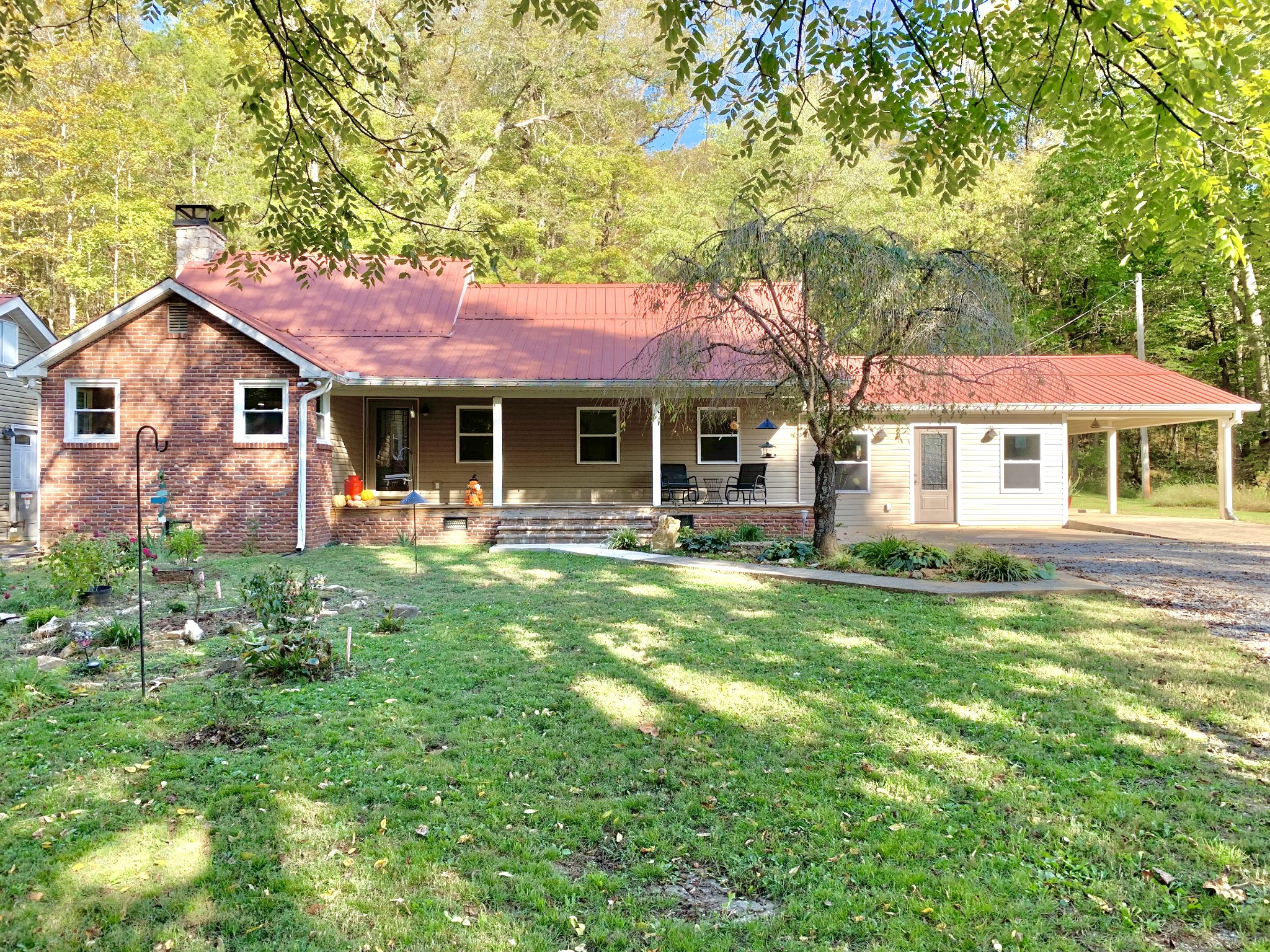 3979 Lem Davis Road Cunningham, TN 37052 - Photo 3 of 70 a front view of a house with a yard table and chairs