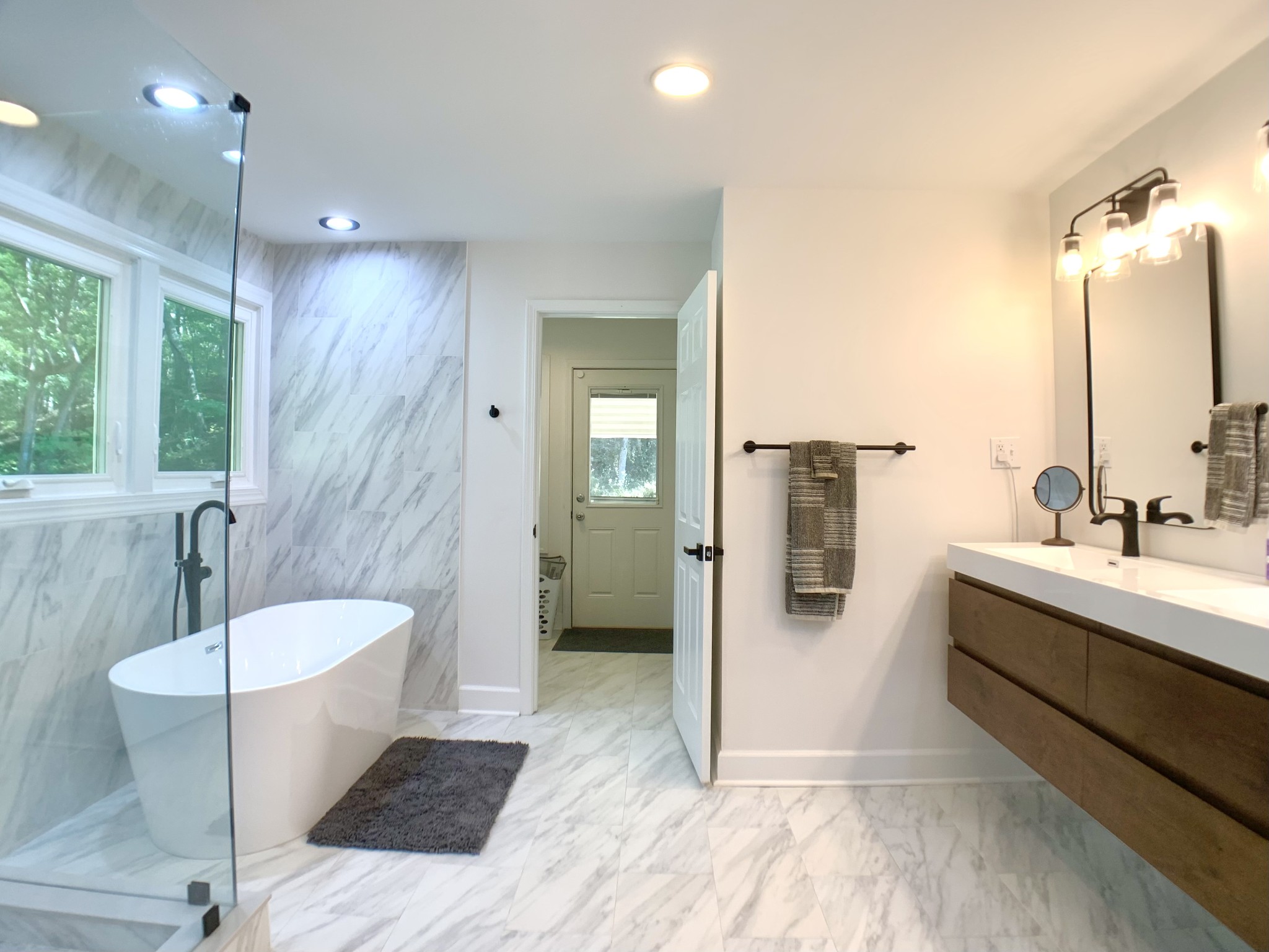 3979 Lem Davis Road Cunningham, TN 37052 - Photo 36 of 70 a bathroom with a double vanity sink a mirror and a bathtub