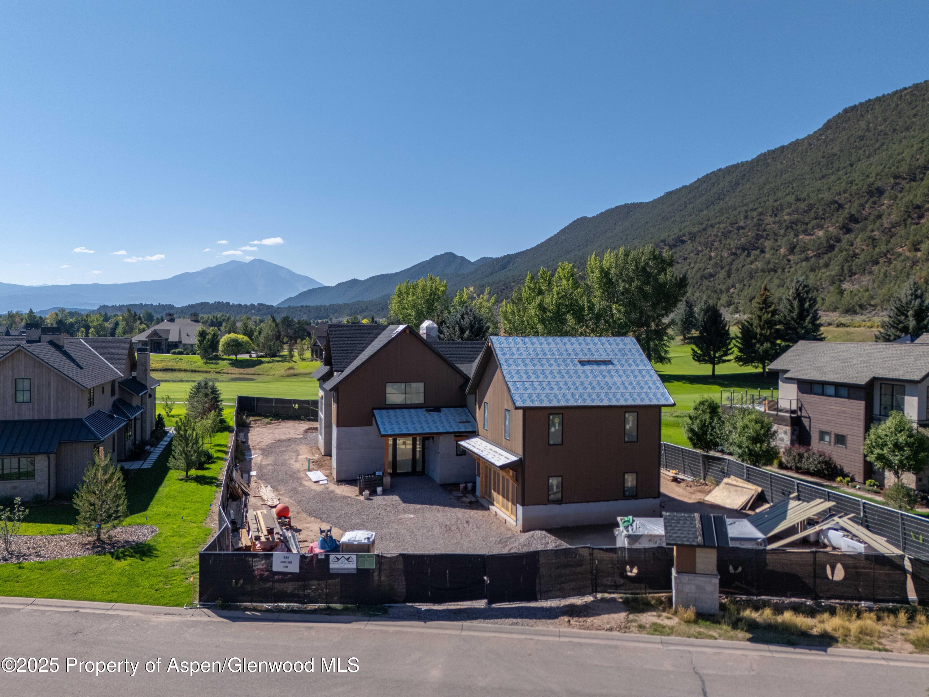 a front view of a house with a garden and parking