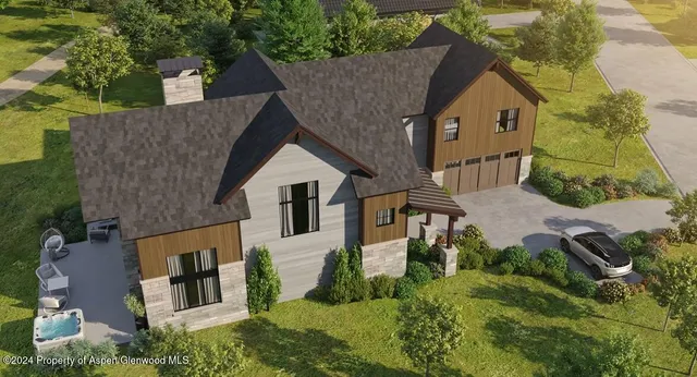 an aerial view of a house with a yard