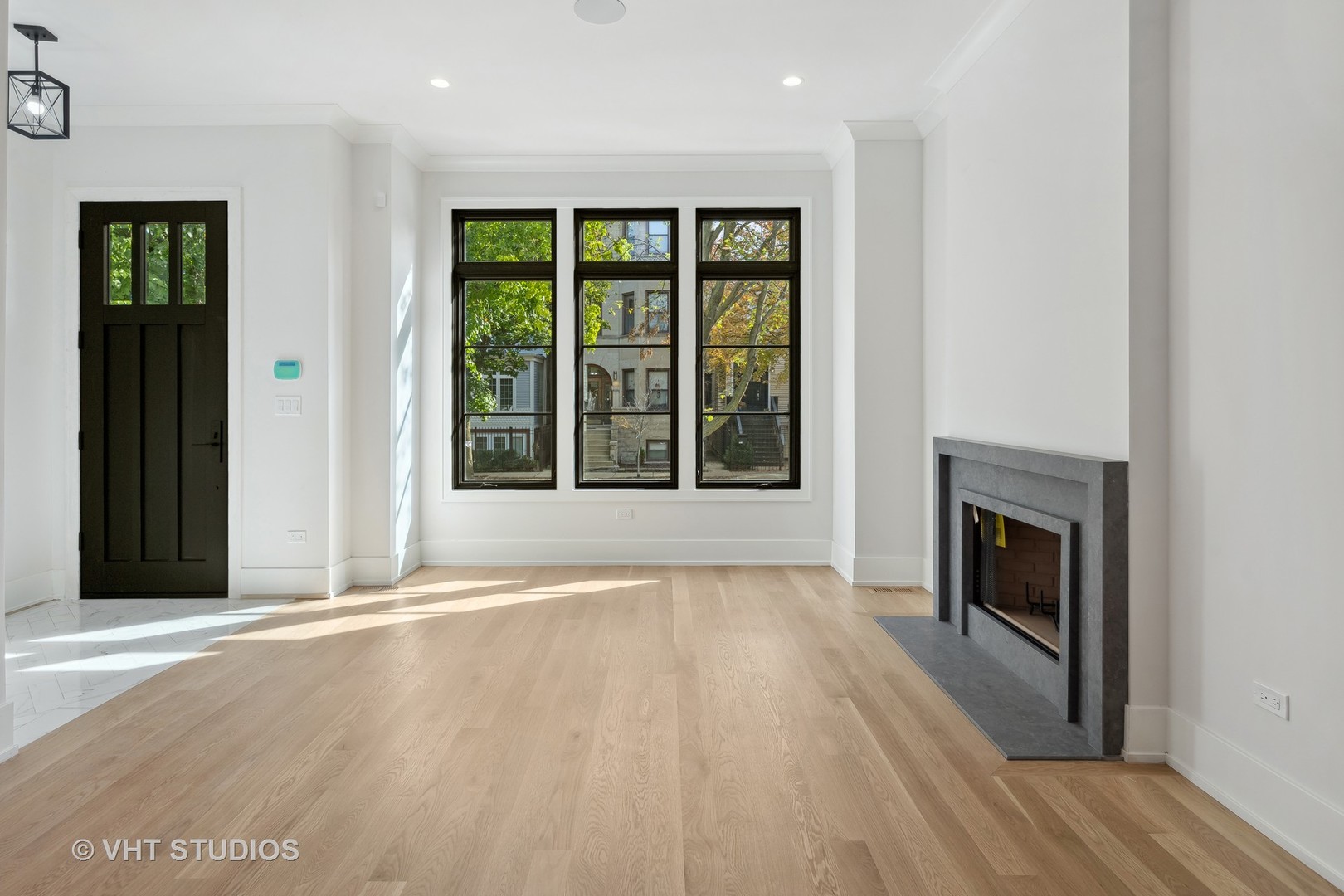 3018 North Seminary Avenue Chicago, IL 60657 - Photo 4 of 62 an empty room with large windows and fireplace