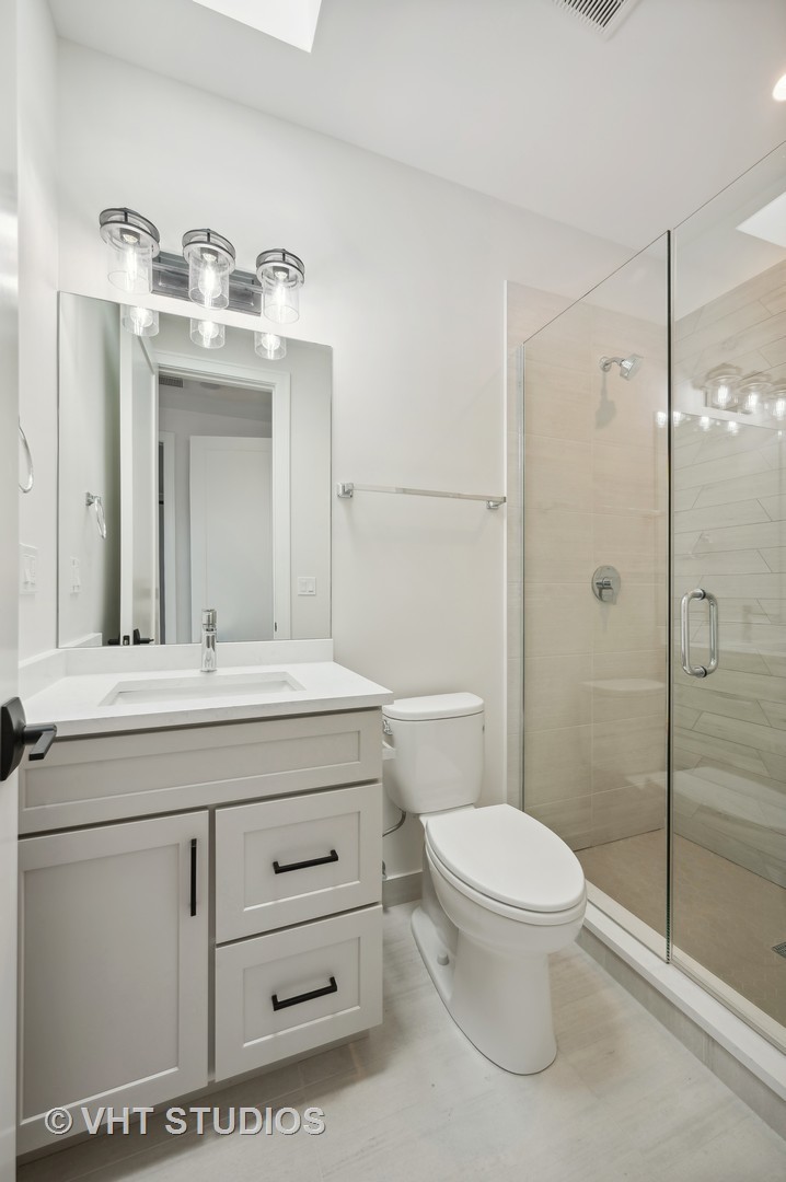 3018 North Seminary Avenue Chicago, IL 60657 - Photo 59 of 62 a bathroom with a sink a toilet and shower