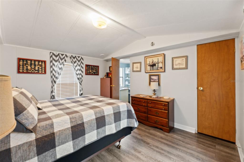7154 County Road 651 Bushnell, FL 33513 - Photo 11 of 34 a bedroom with a bed and wooden floor