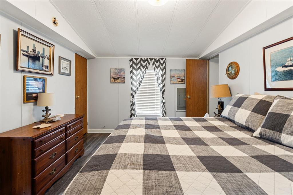 7154 County Road 651 Bushnell, FL 33513 - Photo 12 of 34 a bedroom with a bed and wooden floor