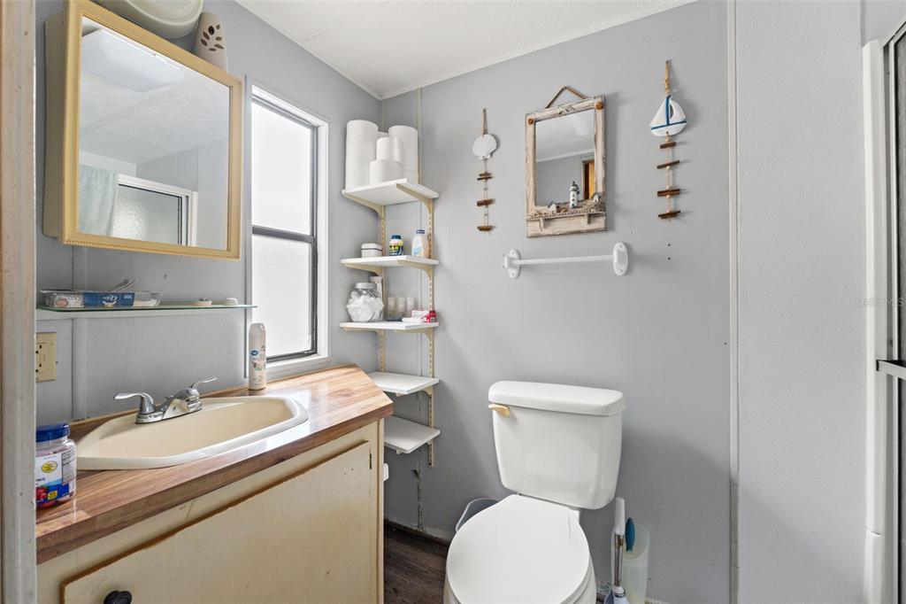 7154 County Road 651 Bushnell, FL 33513 - Photo 14 of 34 a bathroom with a sink toilet and mirror