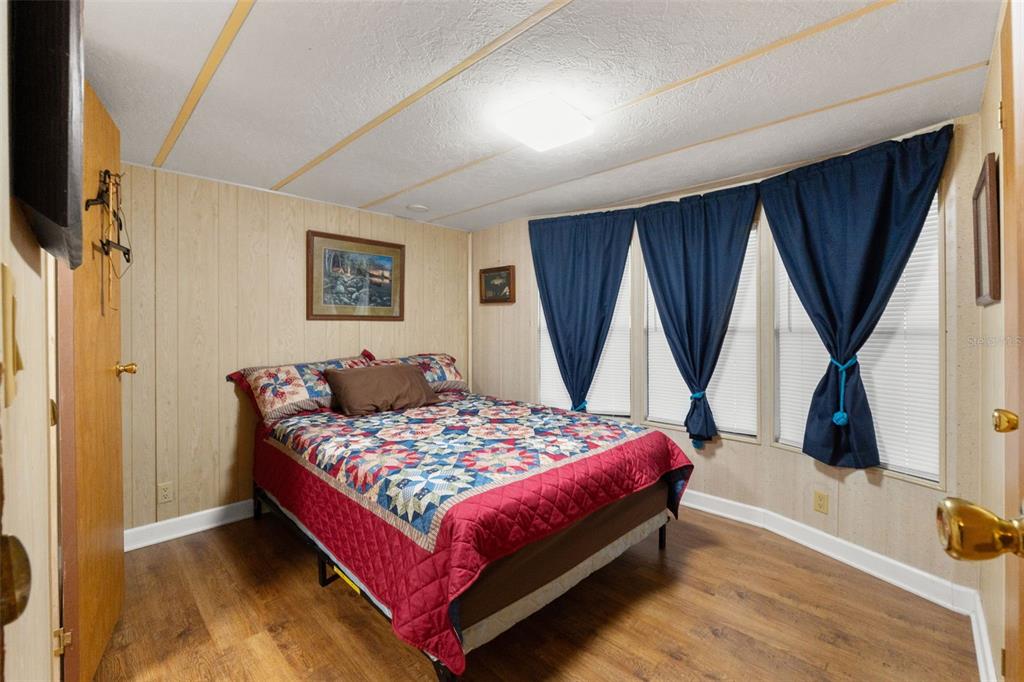 7154 County Road 651 Bushnell, FL 33513 - Photo 15 of 34 a bedroom with a bed closet and a window