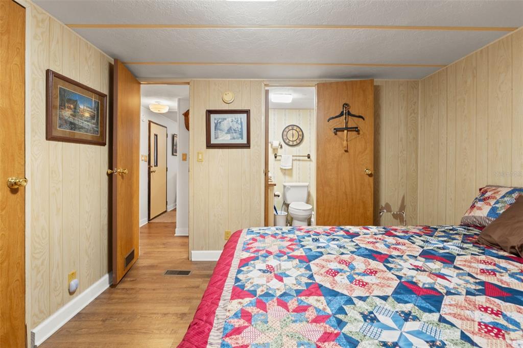 7154 County Road 651 Bushnell, FL 33513 - Photo 16 of 34 a bedroom with a bed and a mirror