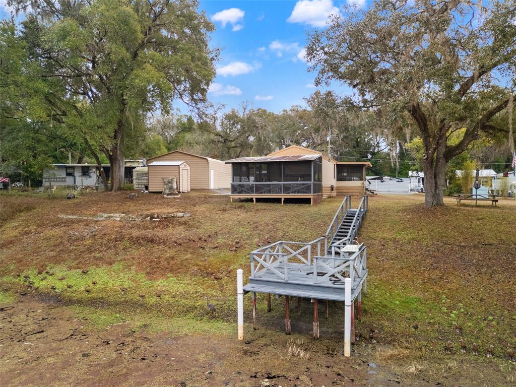 7154 County Road 651 Bushnell, FL 33513 - Photo 25 of 34 a view of a patio with a table chairs and a fire pit