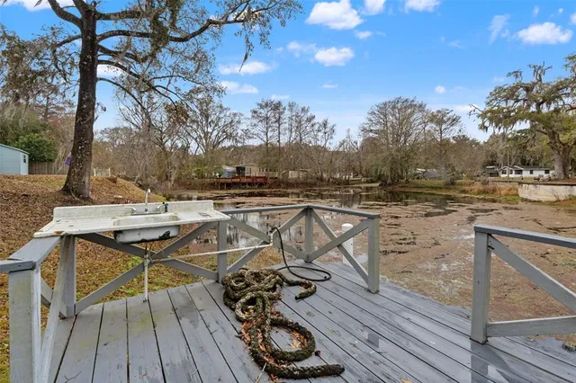 a view of a yard with wooden fence