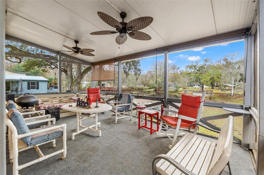 7154 County Road 651 Bushnell, FL 33513 - Photo 5 of 34 a living room with furniture a ceiling fan and a large window