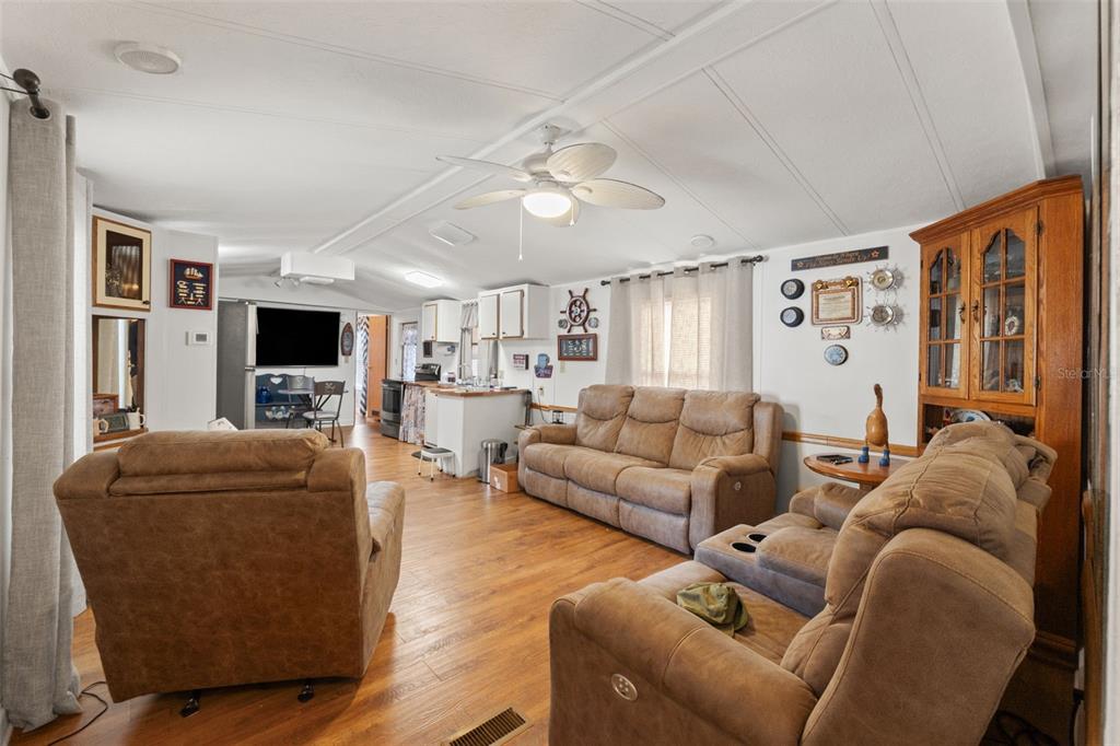 7154 County Road 651 Bushnell, FL 33513 - Photo 6 of 34 a living room with furniture and a flat screen tv