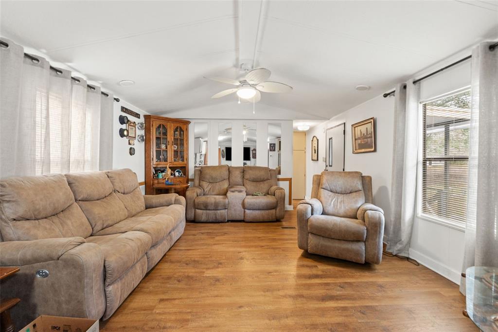 7154 County Road 651 Bushnell, FL 33513 - Photo 7 of 34 a living room with furniture and a large window