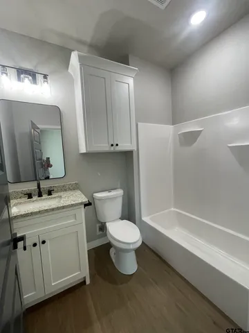 a bathroom with a toilet a sink and a bathtub
