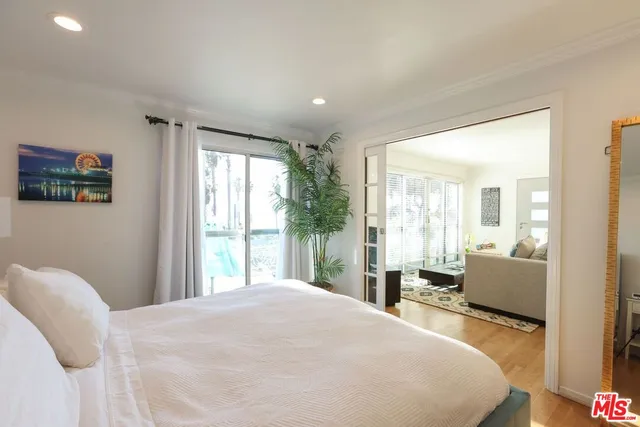 a bedroom with a large bed and a large window