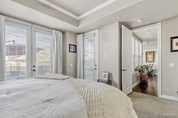 a bedroom with a bed and a large mirror