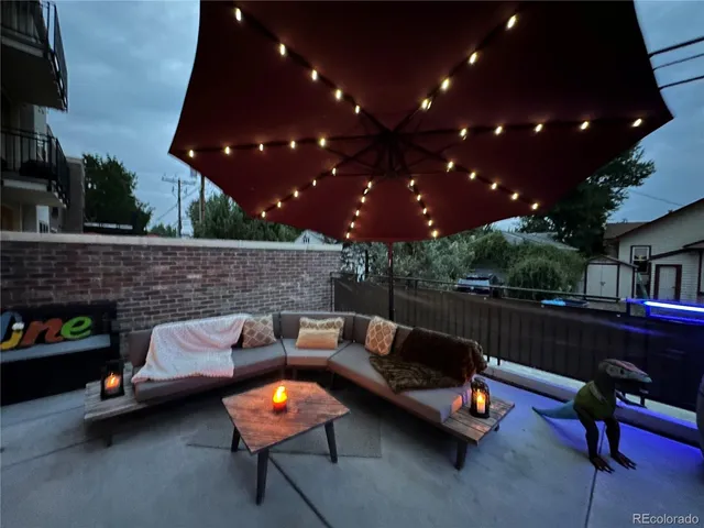 a outdoor living space with furniture and a fireplace