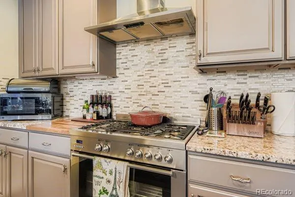 a kitchen with stainless steel appliances sink stove refrigerator and cabinets