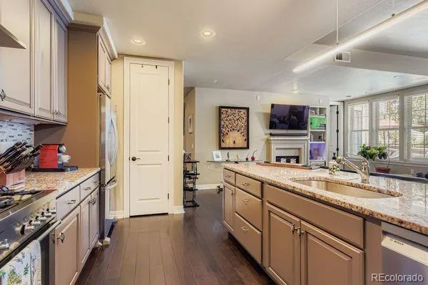 a kitchen with a refrigerator sink and cabinets