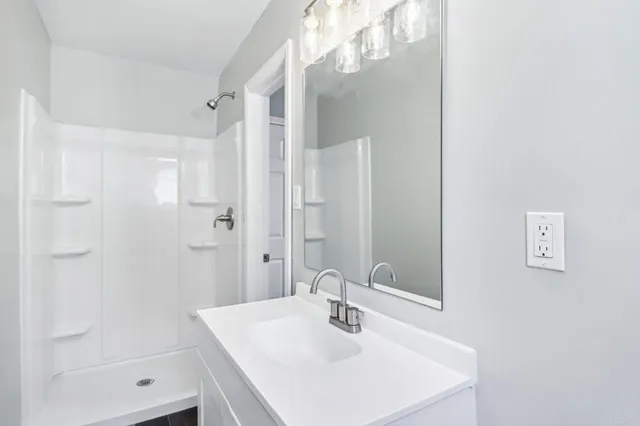 a bathroom with a sink toilet and a mirror