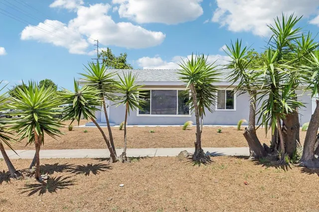 a kitchen with cabinets stainless steel appliances and a window