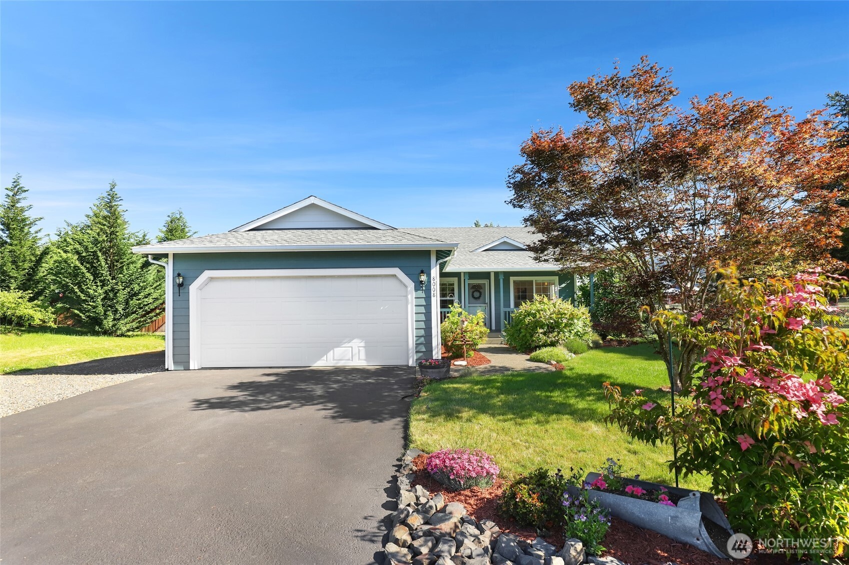 8008 188th Avenue Southwest Rochester, WA 98579 - Photo 2 of 40 a front view of a house with a yard and garage