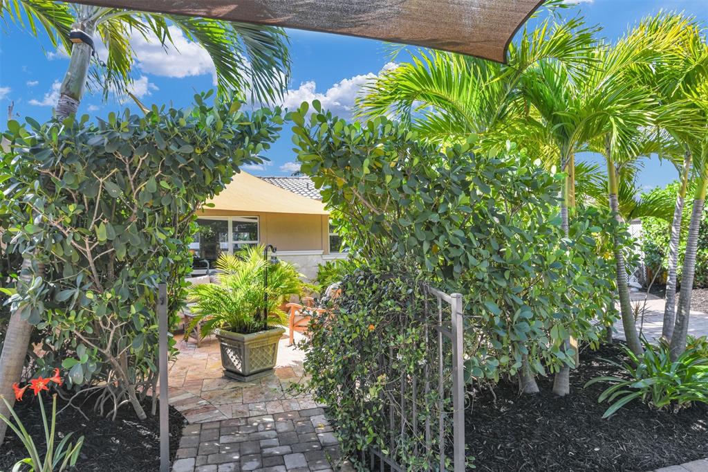 1616 Southeast 4th Street Deerfield Beach, FL 33441 - Photo 11 of 52 a front view of a house with a garden