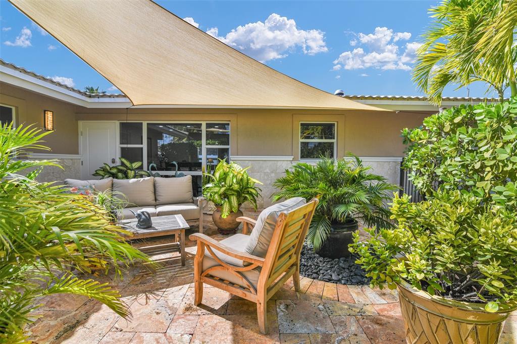 1616 Southeast 4th Street Deerfield Beach, FL 33441 - Photo 16 of 52 a view of a house with backyard and sitting area