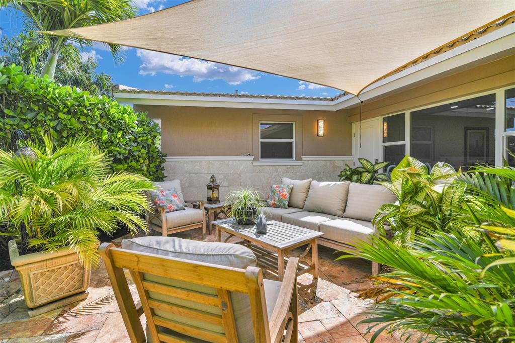 1616 Southeast 4th Street Deerfield Beach, FL 33441 - Photo 17 of 52 a view of a patio with table and chairs and potted plants