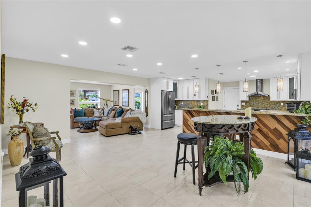 1616 Southeast 4th Street Deerfield Beach, FL 33441 - Photo 23 of 52 a living room with furniture and a dining table with kitchen view