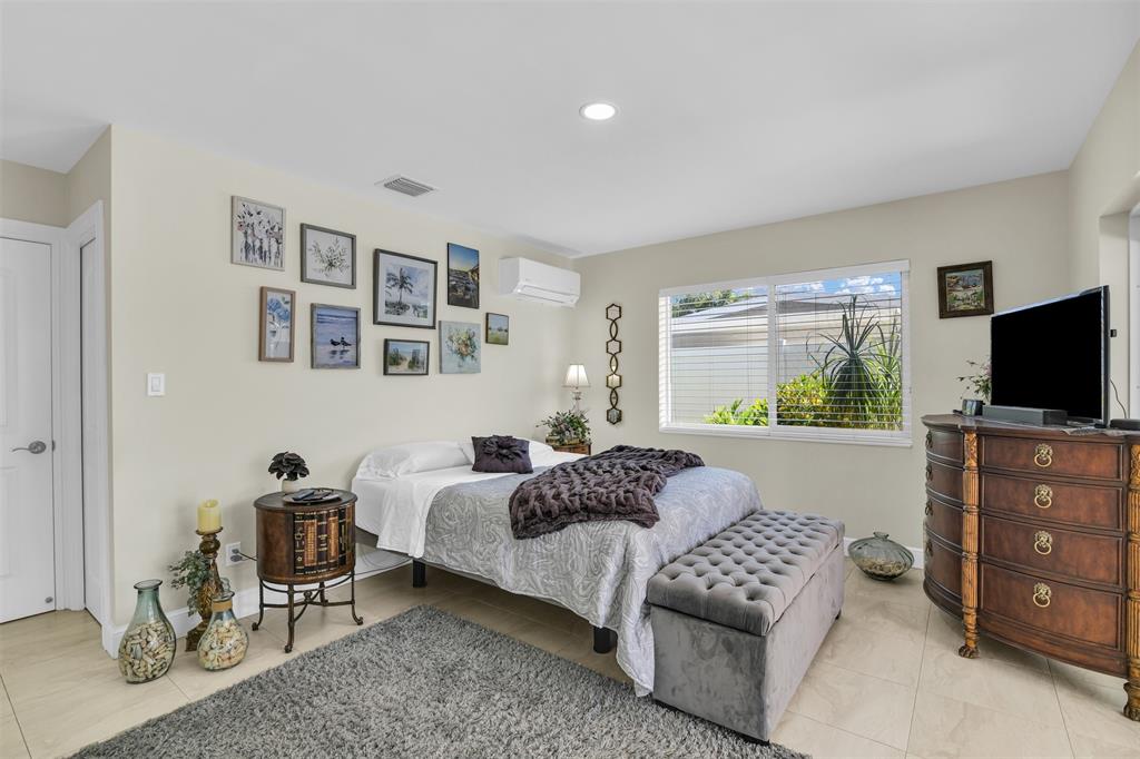 1616 Southeast 4th Street Deerfield Beach, FL 33441 - Photo 39 of 52 a bedroom with a bed and furniture